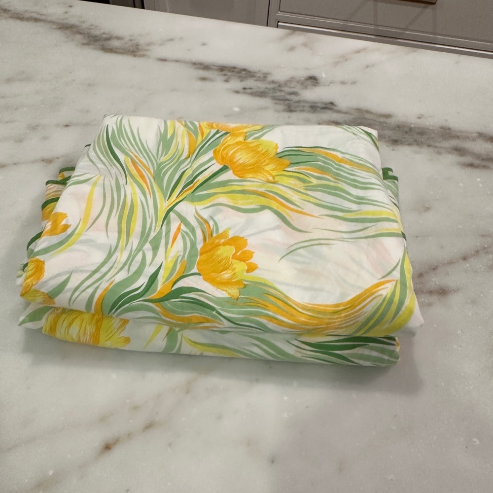 D Porthault round tablecloths with Green and yellow tulips.